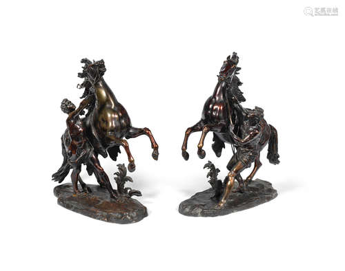 After Guillaume Coustou the Elder (French, 1677-1746): A large pair of late 19th century patinated bronze models of the Marly Horses