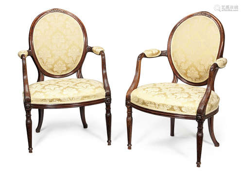 A pair of George III carved mahogany open armchairs