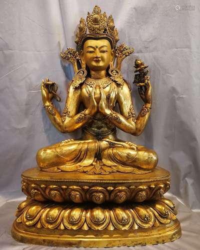 A BRONZE GILT FOUR ARMS OF GUANYIN FIGURE