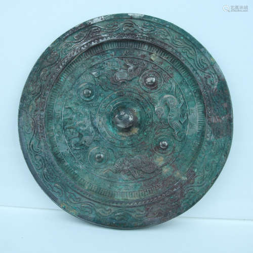 AN UNEARTHED BRONZE MIRROR