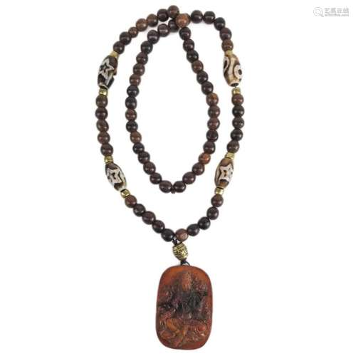 A Carved Bone and Dzi Agate Bead Necklace