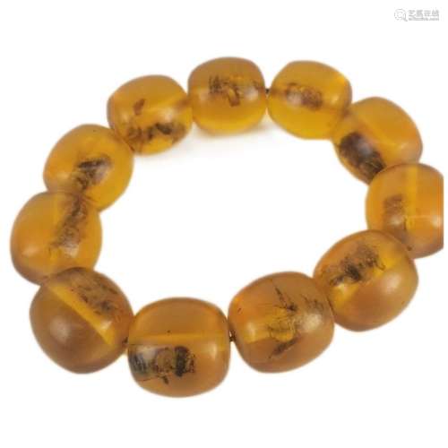 A Polished Yellow Amber Bracelet with Insect Inclusions