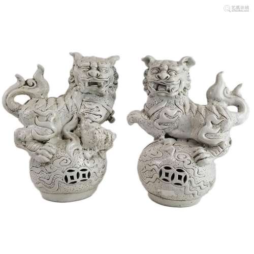 A Pair of White Glazed Foo Dogs on a ball of Clouds