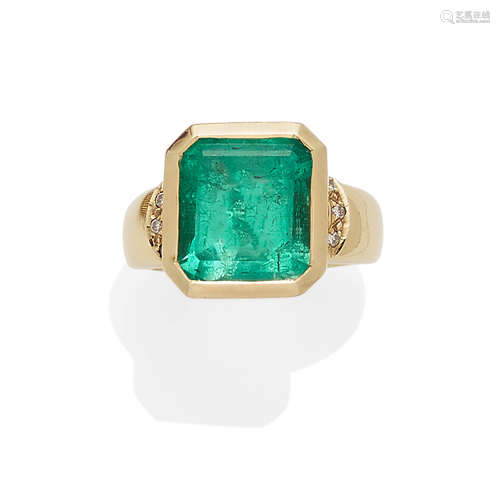 An emerald, diamond and gold ring