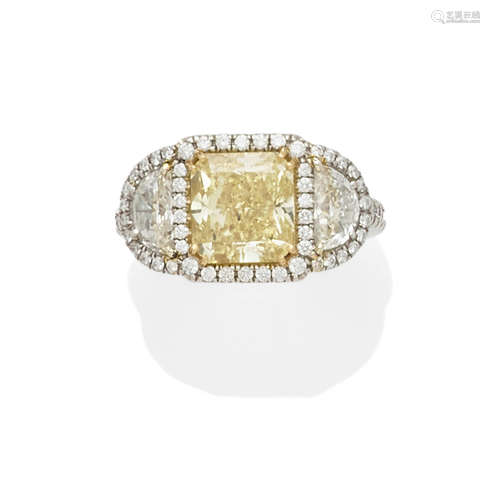 A Natural Fancy Yellow diamond, diamond and platinum ring