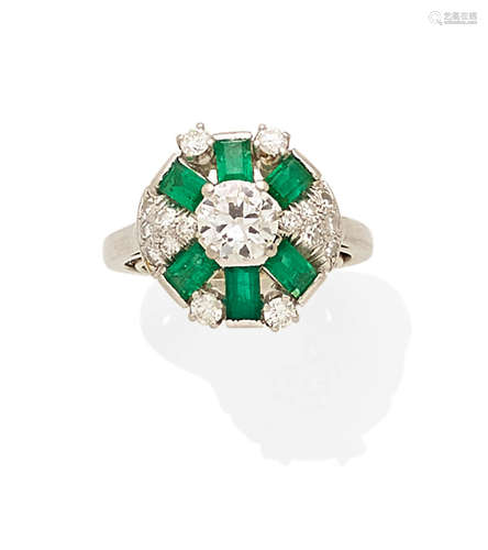 An emerald, diamond and platinum ring