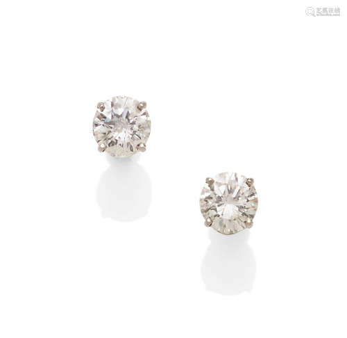 A pair of diamond and 14k white gold stud earrings
