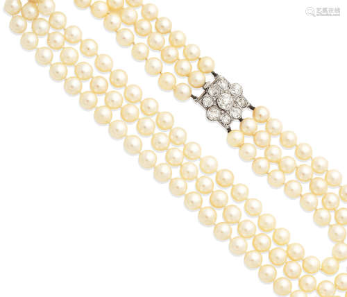 A three-strand cultured pearl necklace with a diamond clasp