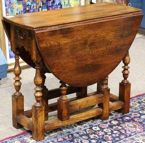 Georgian style drop leaf gateleg table, having a single drawer, and rising on turned legs, 26