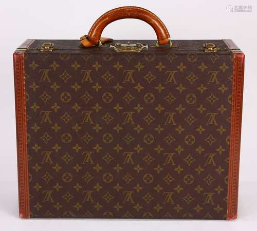 Louis Vuitton Paris Coteville hard shell suitcase, with the classic brown and gold 