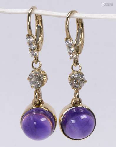 Pair of amethyst, diamond and 14k yellow gold earrings Featuring (2) round amethyst cabochons,