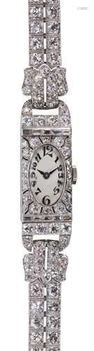 Lady's Art Deco diamond and platinum wristwatch Dial: oval, white, black stylized Arabic numeral