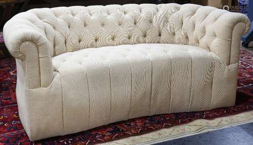 Moderne Chesterfield style sofa, having a shaped profile with tufted beige upholstery, 28