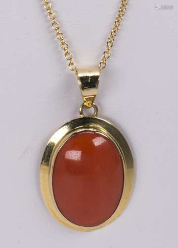 Coral and 18k yellow gold pendant-necklace Featuring (1) oval coral cabochon, measuring