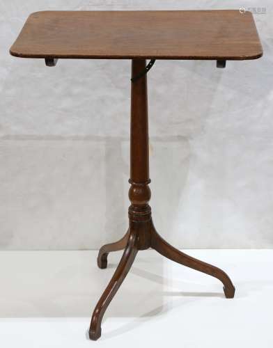 Federal mahogany tilt top table, having a rectangular top, above a turned standard, and rising on