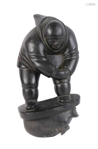 Eskimo carved sculpture by Johnny Inukpuk (Inuit, 1911-2007), depicting an Eskimo surmounting a