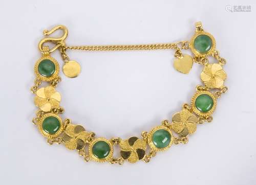 Jadeite and 22k yellow gold bracelet Featuring (6) round jadeite cabochons, measuring