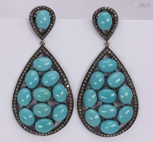 Pair of turquoise, diamond and blackened silver ear pendants Featuring (22) oval turquoise