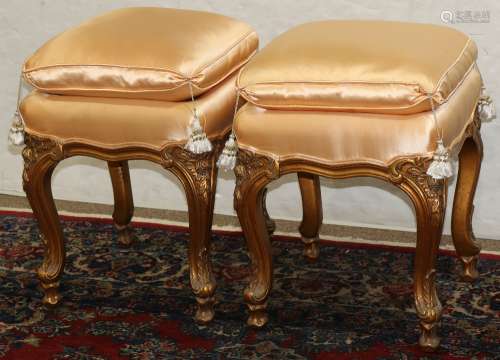 Louis XV style giltwood benches, each having an apricot upholstered cushion, and rising on