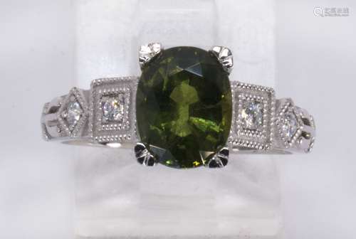 Sapphire, diamond and platinum ring Featuring (1) oval-cut green sapphire, weighing approximately