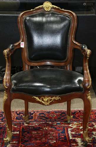 Louis XV style fauteuil, having a partial gilt shell decorated crest, above black upholstery