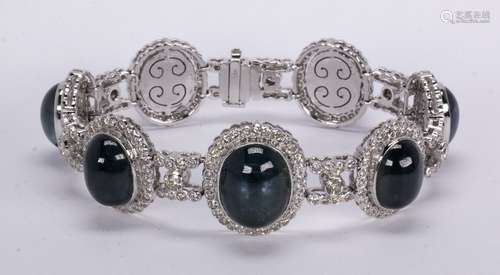 Sapphire, diamond and 18k white gold bracelet Featuring (7) oval sapphire cabochons, ranging in size