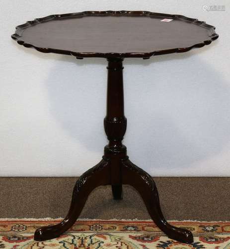 English mahogany tilt top tea table, 19th century, have a pie crust top, above a baluster