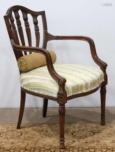 Federal style carved armchair, having a shield form back, the arms with geometric and leaf form