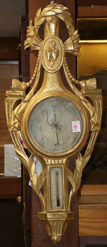 French Louis XV style barometer circa 1850, having a giltwood carved case with two windows, the