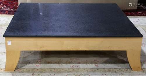 Italian Moderne style occasional table, having a square black quartz top, above a blondewood