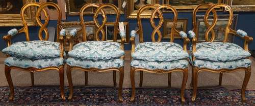 (lot of 4) Louis XV style giltwood armchairs, each having a pierced back, above a blue cushion,