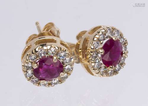 Pair of ruby, diamond and 14k yellow gold earrings Centering (2) round-cut rubies, weighing a