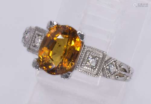 Sapphire, diamond and platinum ring Featuring (1) oval-cut orange sapphire, weighing approximately