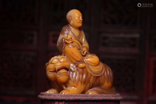 A TIANHUANG SOAPSTONE CARVED LUOHAN FIGURE