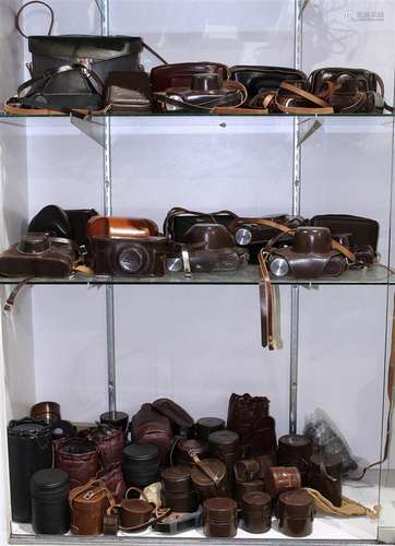 Three shelves of Leica cases