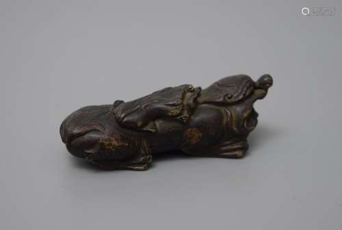 A BRONZE 'MYTHICAL BEAST' BRUSH REST, QING DYNASTY