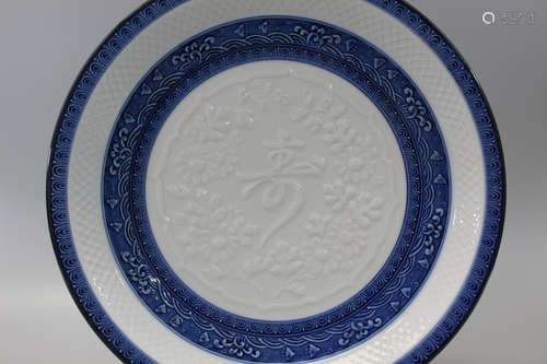 Japanese blue and white porcelain charger with carved flower and longevity character decorations.