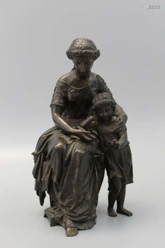 A bronze statue of a lady and a girl.