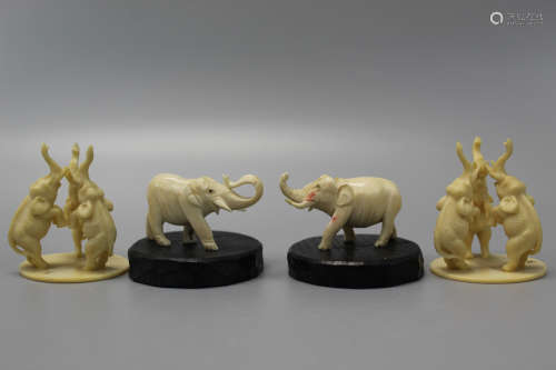 Four carved decorative elephants.