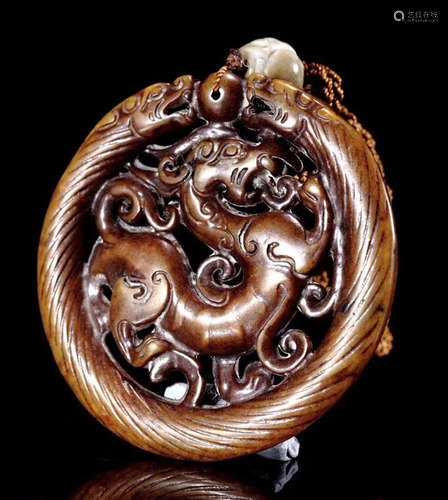 A HETIAN JADE DRAGON AND TIGER PENDANT