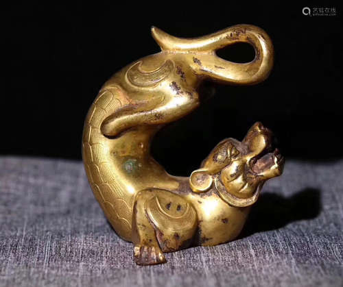 A GILT BRONZE MOLDED BEAST SHAPED FIGURE