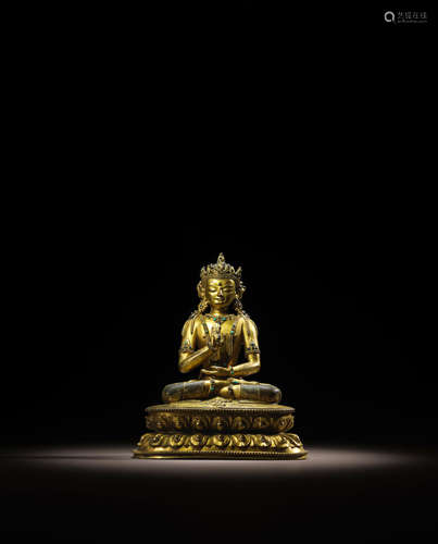 TIBET, CIRCA 15TH CENTURY A GILT COPPER ALLOY FIGURE OF AMOGHASIDDHI