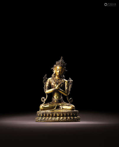 TIBET, CIRCA 15TH CENTURY A GILT COPPER ALLOY FIGURE OF VAJRADHARA