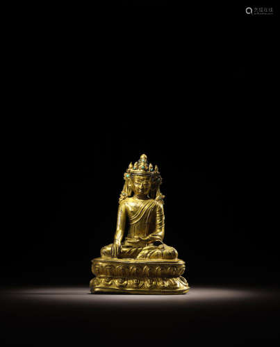 TIBET, CIRCA 16TH CENTURY A GILT COPPER ALLOY FIGURE OF CROWNED BUDDHA
