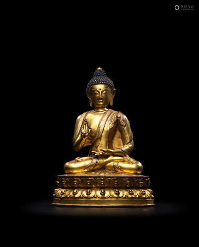 TIBET, 15TH CENTURY A GILT COPPER ALLOY FIGURE OF AMOGHASIDDHI