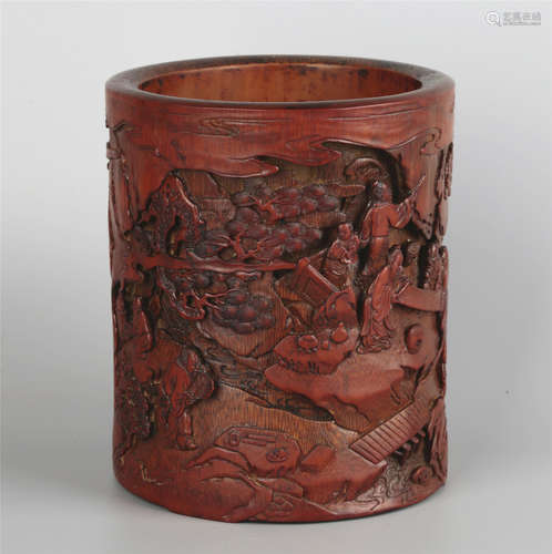 A CARVED WOOD FIGURE BRUSHPOT