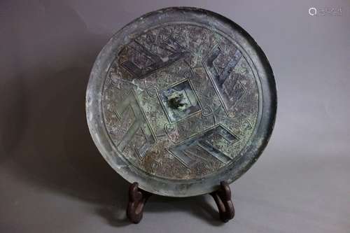 A BRONZE CIRCULAR MIRROR