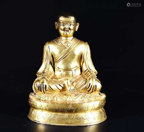 A GILT-BRONZE FIGURE OF A LAMA