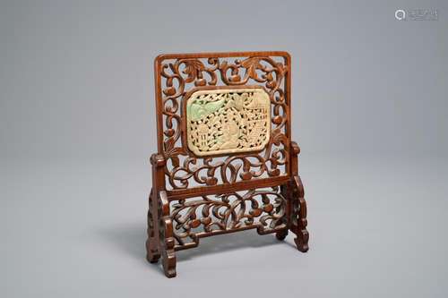 A small Chinese jade plaque mounted in a carved wood table screen, 19/20th C.