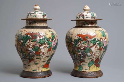 A pair of Chinese Nanking famille rose vases and covers with warriors, 19/20th C.